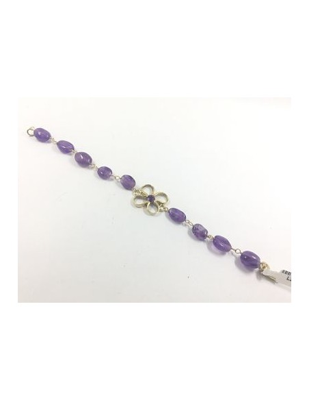 Pulsera de oro y  piedras color violeta.