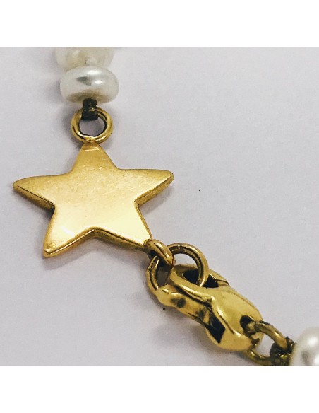 Pulsera de perlas con estrella en oro 18kt.